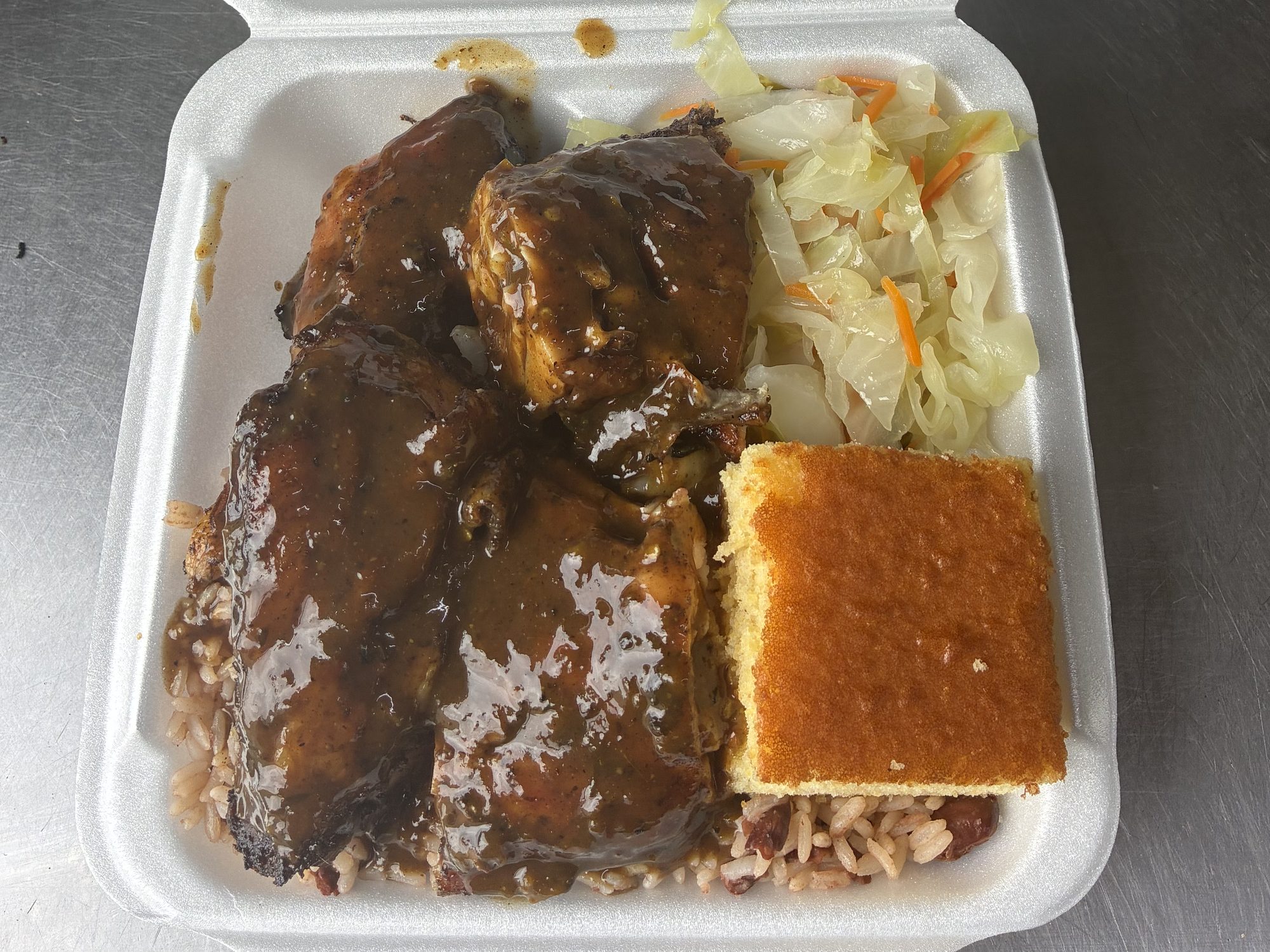Jerk chicken with rice and peas, steamed cabbage and cornbread